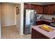 Spacious kitchen with stainless steel refrigerator, center island and plenty of counter space at 6141 Annville Ct, North Las Vegas, NV 89081