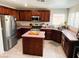 Well-lit kitchen features wood cabinetry, stainless steel appliances, and an island at 6141 Annville Ct, North Las Vegas, NV 89081