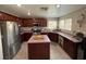 Well-lit kitchen featuring a center island, stainless steel appliances, and wooden cabinetry at 6141 Annville Ct, North Las Vegas, NV 89081