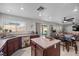 Kitchen with stainless appliances, island, backyard view, and open access to the dining and living areas at 6141 Annville Ct, North Las Vegas, NV 89081