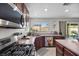 Bright kitchen featuring stainless steel appliances, an island, and a view of the backyard at 6141 Annville Ct, North Las Vegas, NV 89081