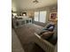 Spacious living room with carpeted floors, light gray walls, and modern furniture at 6141 Annville Ct, North Las Vegas, NV 89081