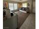 Living room featuring tile flooring, a daybed, a large window, and a custom reptile enclosure at 6141 Annville Ct, North Las Vegas, NV 89081