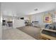 Open living room with tile entry, neutral carpet and a cozy seating area at 6141 Annville Ct, North Las Vegas, NV 89081