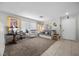 Neutral living room with tile entry, neutral carpet and ample natural light at 6141 Annville Ct, North Las Vegas, NV 89081