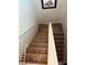 Carpeted staircase with white railings and neutral-colored walls at 6141 Annville Ct, North Las Vegas, NV 89081