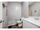 Neutral half-bathroom featuring white vanity, modern toilet, and plank flooring at 6228 Haiku Stairs St, Las Vegas, NV 89148