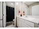 Bathroom featuring single sink vanity, toilet, and shower with dark curtain at 6228 Haiku Stairs St, Las Vegas, NV 89148