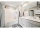 Bright bathroom features a tiled shower over tub and dual sink vanity at 6228 Haiku Stairs St, Las Vegas, NV 89148