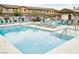 Community pool showcasing sun loungers, clear water, and nearby shelter, promising relaxation and recreation at 6228 Haiku Stairs St, Las Vegas, NV 89148