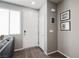 Entryway featuring hardwood floors, a white entry door, and decorative wall art at 6228 Haiku Stairs St, Las Vegas, NV 89148