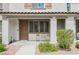 Townhouse featuring a covered entry, neutral exterior, and a small seating area on the front porch at 6228 Haiku Stairs St, Las Vegas, NV 89148