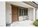 Close-up of the townhouse entrance with a covered porch and cozy seating area outside the front door at 6228 Haiku Stairs St, Las Vegas, NV 89148
