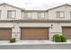 Exterior view of attached garages with brown doors and manicured landscaping for added curb appeal at 6228 Haiku Stairs St, Las Vegas, NV 89148