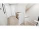 Hallway with access to garage entry featuring beige walls and carpet flooring at 6228 Haiku Stairs St, Las Vegas, NV 89148
