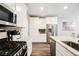 Modern kitchen featuring stainless steel appliances, white cabinetry, and granite countertops for a sleek design at 6228 Haiku Stairs St, Las Vegas, NV 89148