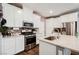 Bright kitchen featuring white cabinets, granite countertops, stainless steel appliances, and a stylish brick backsplash at 6228 Haiku Stairs St, Las Vegas, NV 89148