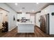 Bright kitchen featuring white cabinets, granite countertops, stainless steel appliances, and a stylish brick backsplash at 6228 Haiku Stairs St, Las Vegas, NV 89148