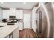 Bright kitchen featuring white cabinets, granite countertops, stainless steel appliances, and brick backsplash at 6228 Haiku Stairs St, Las Vegas, NV 89148
