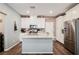Bright kitchen featuring white cabinets, granite countertops, stainless steel appliances, and a stylish brick backsplash at 6228 Haiku Stairs St, Las Vegas, NV 89148