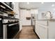 Modern kitchen featuring stainless steel appliances, white cabinetry, and granite countertops for a sleek design at 6228 Haiku Stairs St, Las Vegas, NV 89148