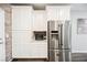 This bright kitchen features white cabinets, stainless steel refrigerator, and brick wall accents at 6228 Haiku Stairs St, Las Vegas, NV 89148