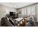 Comfortable living room with a sectional sofa, a TV, and ample natural light at 6228 Haiku Stairs St, Las Vegas, NV 89148