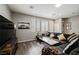 Living room boasts a large sectional, mounted TV, and a marble-topped coffee table at 6228 Haiku Stairs St, Las Vegas, NV 89148