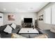 Comfortable living room featuring a modern sectional sofa and a large-screen television with decorative accents at 6228 Haiku Stairs St, Las Vegas, NV 89148