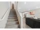 Carpeted staircase with white railing, leading to the kitchen and living area at 6228 Haiku Stairs St, Las Vegas, NV 89148
