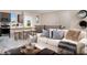 Open floor plan with modern kitchen that flows into a living area with comfortable seating and decor at 627 Bellus Pl # Lot 156, Henderson, NV 89015