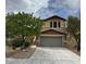 Charming two-story home featuring desert landscaping, a two-car garage, and inviting curb appeal at 6449 Lake Scene St, Las Vegas, NV 89148