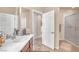Bathroom with a single vanity, a large mirror, and a glass enclosed shower at 6453 Mount Eden Ave, Las Vegas, NV 89139