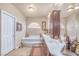 Bright bathroom features a soaking tub, tiled floors, and a large vanity with lots of counterspace at 6453 Mount Eden Ave, Las Vegas, NV 89139