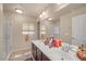 Bathroom featuring a double sink, lots of storage, a glass shower and neutral decor at 6453 Mount Eden Ave, Las Vegas, NV 89139