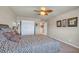 Bedroom with patterned bedding, a ceiling fan, and access to hall at 6453 Mount Eden Ave, Las Vegas, NV 89139