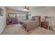 Cozy bedroom features a ceiling fan, neutral walls, and a large window for plenty of natural light at 6453 Mount Eden Ave, Las Vegas, NV 89139