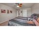 Comfortable bedroom with a ceiling fan, neutral walls, and view into the hallway at 6453 Mount Eden Ave, Las Vegas, NV 89139
