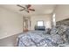 Bedroom featuring ceiling fan, a large bed, and a dresser with mirror at 6453 Mount Eden Ave, Las Vegas, NV 89139