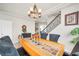 Elegant dining area featuring a decorative chandelier, table runner, and staircase at 6453 Mount Eden Ave, Las Vegas, NV 89139