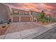Stunning two-story home featuring a three-car garage and mature landscaping at 6453 Mount Eden Ave, Las Vegas, NV 89139