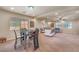 Bright living room featuring plush seating, modern decor, and a dining table at 6453 Mount Eden Ave, Las Vegas, NV 89139
