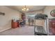 Home office features a desk, rolling chair, a treadmill, and a window overlooking the backyard at 6453 Mount Eden Ave, Las Vegas, NV 89139