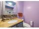 Bathroom featuring granite counters, a vessel sink, and a decorative mirror at 6655 Flaminian Ln # 104, North Las Vegas, NV 89084