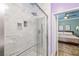 Bathroom with glass shower, marble tiling, and access to main bedroom at 6655 Flaminian Ln # 104, North Las Vegas, NV 89084
