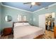 Cozy bedroom features blue ceiling, comfortable bed, and walk-in closet at 6655 Flaminian Ln # 104, North Las Vegas, NV 89084