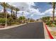 Gated community entrance with lush landscaping and secure access at 6655 Flaminian Ln # 104, North Las Vegas, NV 89084