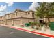 Exterior view of condominium buildings, private garages, and landscape at 6655 Flaminian Ln # 104, North Las Vegas, NV 89084