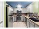 Updated kitchen featuring stainless steel appliances, tile backsplash, and ample counter space at 6655 Flaminian Ln # 104, North Las Vegas, NV 89084