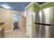 Galley kitchen leading into another room showcases stainless steel refrigerator at 6655 Flaminian Ln # 104, North Las Vegas, NV 89084